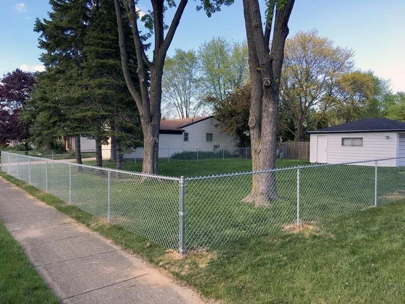 Galvanized chain-link fence securing a property perimeter