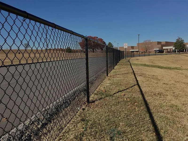Galvanized chain-link fence enclosing a yard
